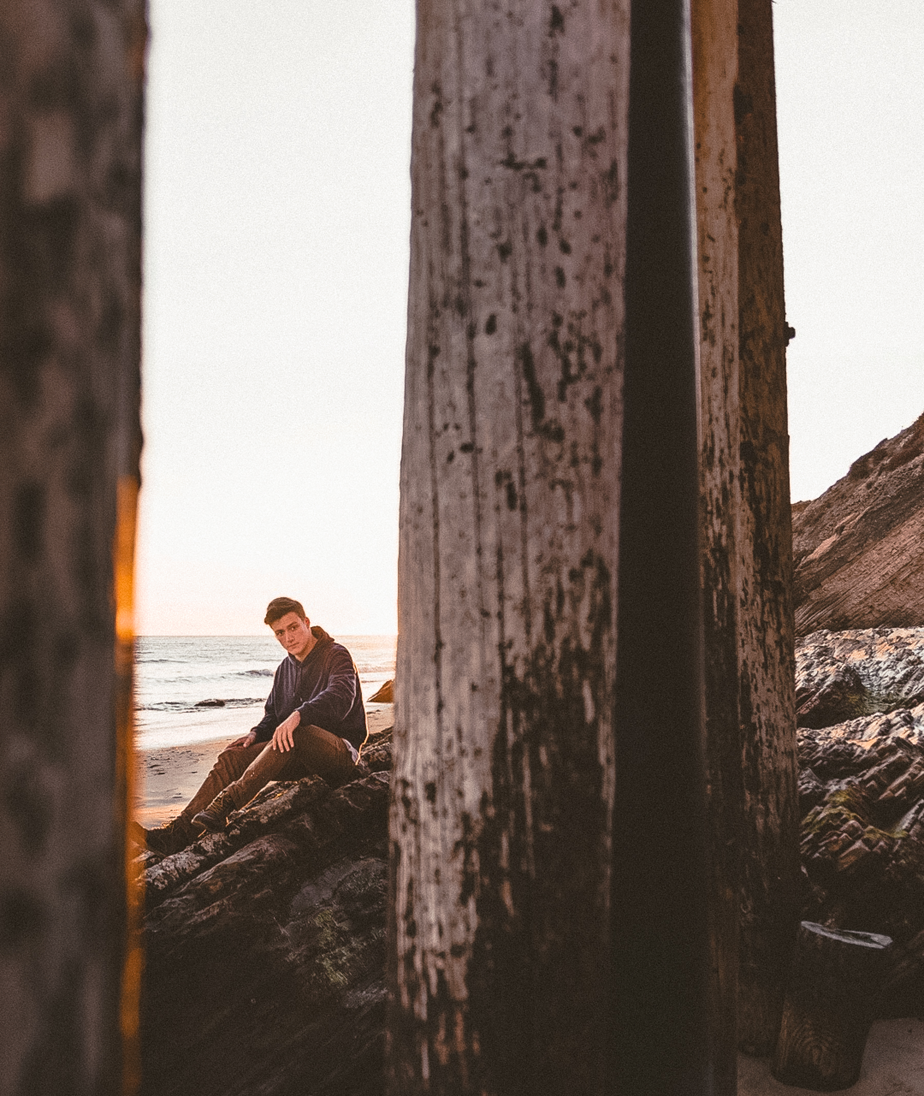 Cade sitting on rocks at the beach