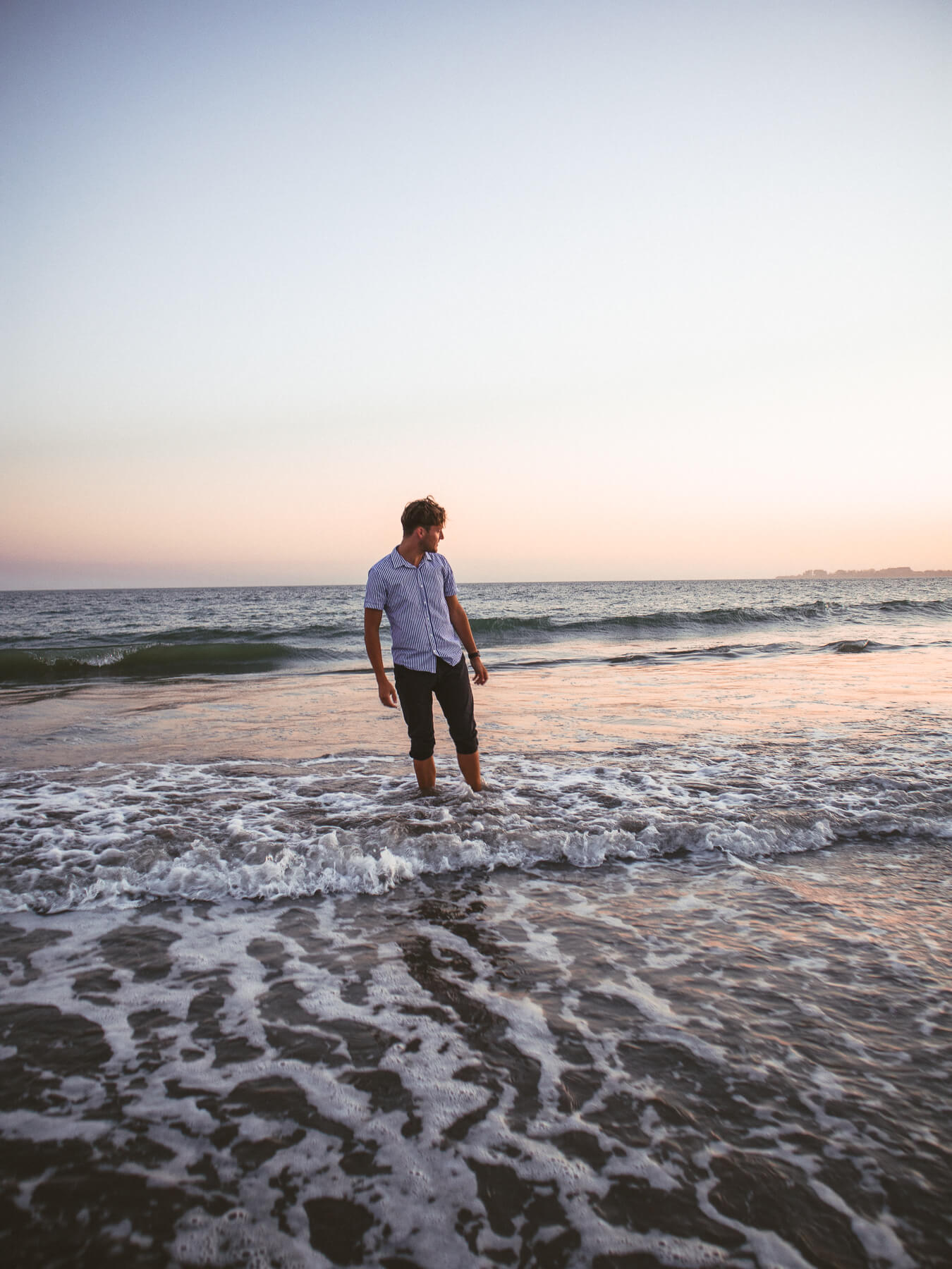 Cade standing in ocean